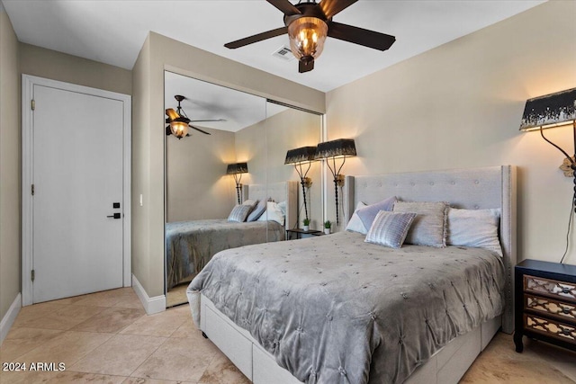 tiled bedroom featuring a closet and ceiling fan