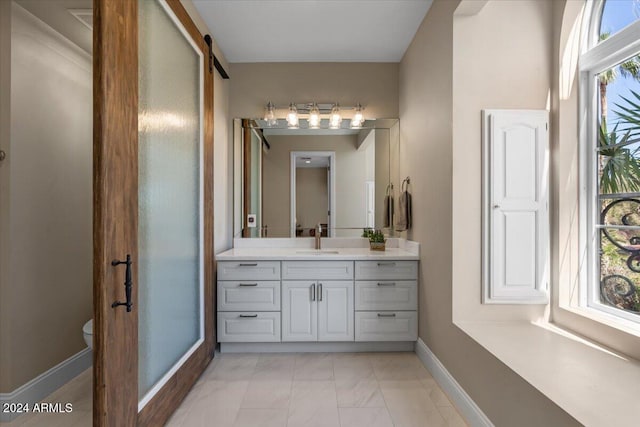 bathroom featuring vanity, toilet, and a wealth of natural light