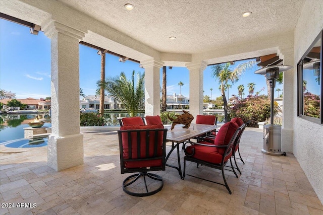 view of patio with a water view