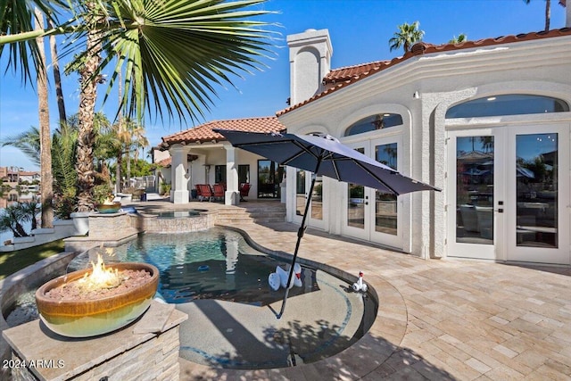 view of pool featuring french doors, a patio, and an in ground hot tub