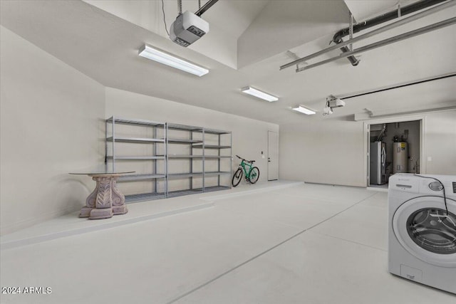 garage with washer / dryer, a garage door opener, and water heater