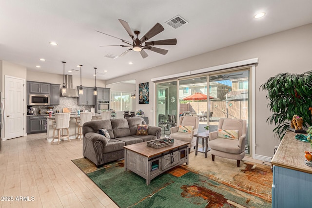 living room featuring ceiling fan and dark hardwood / wood-style flooring