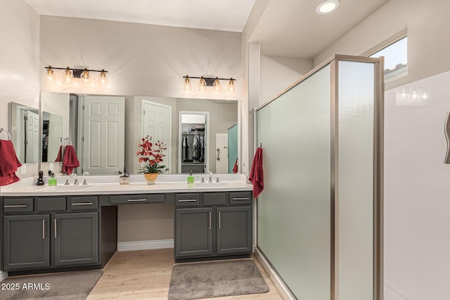 bathroom featuring vanity, an enclosed shower, and hardwood / wood-style floors