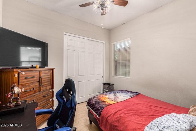 bedroom featuring ceiling fan, a closet, and light hardwood / wood-style flooring