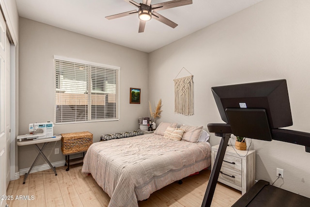 bedroom featuring light hardwood / wood-style flooring, ceiling fan, and a closet