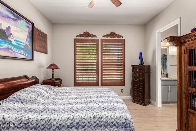 bedroom featuring multiple windows, connected bathroom, ceiling fan, and light hardwood / wood-style floors