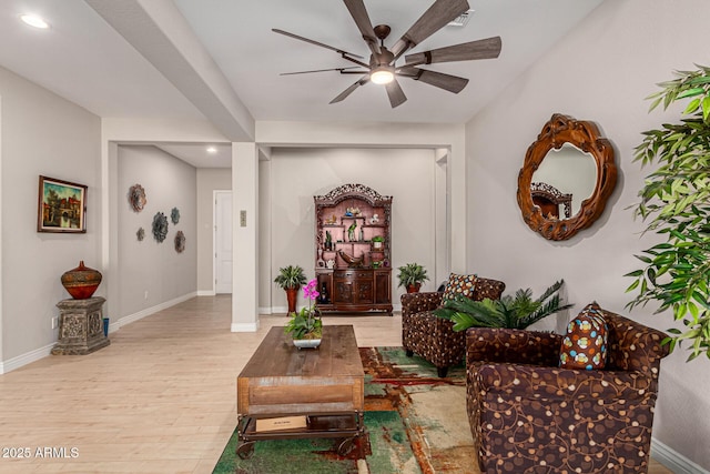 living room featuring light hardwood / wood-style floors and ceiling fan