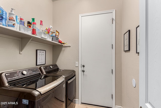 laundry room with washing machine and clothes dryer