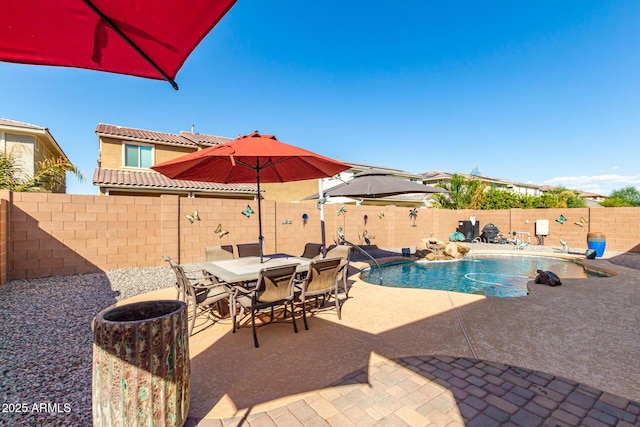 view of pool with pool water feature and a patio