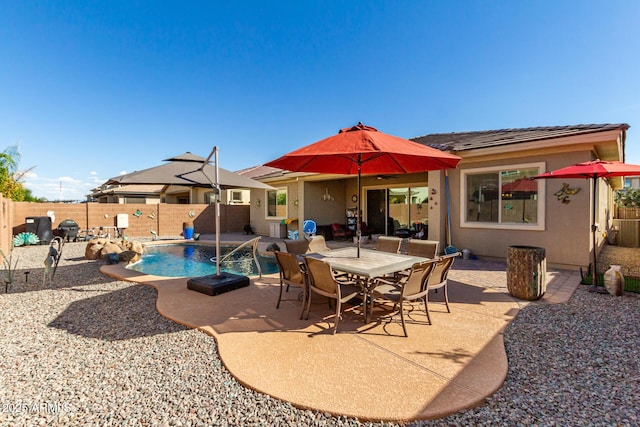 view of pool with pool water feature, central AC unit, and a patio area