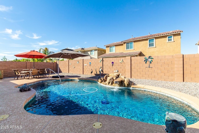 view of pool featuring pool water feature and a patio area