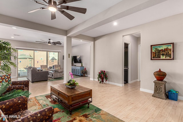 living room with beam ceiling, ceiling fan, and light hardwood / wood-style floors