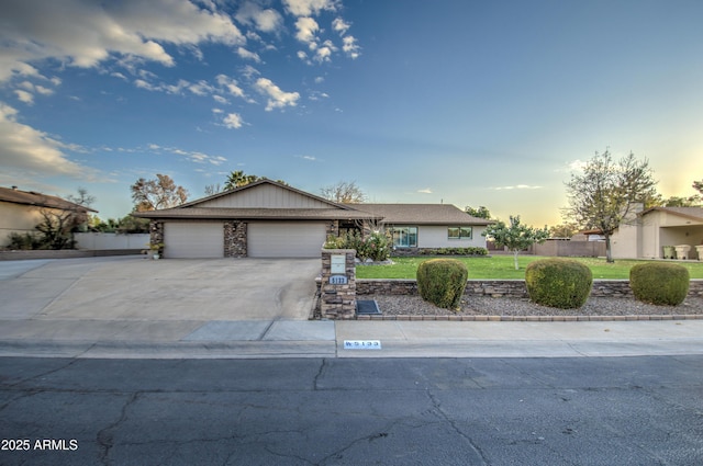 ranch-style home featuring a yard and a garage