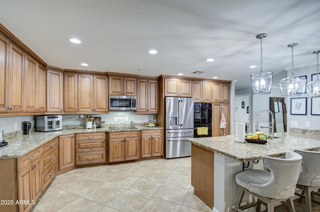 kitchen with a kitchen bar, kitchen peninsula, light stone counters, and appliances with stainless steel finishes