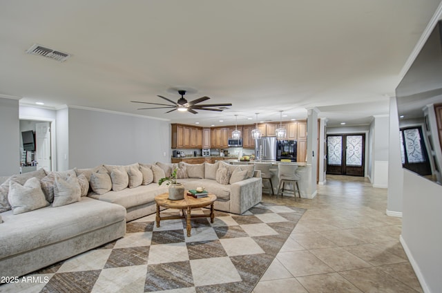 living room with ceiling fan, light tile patterned floors, and crown molding