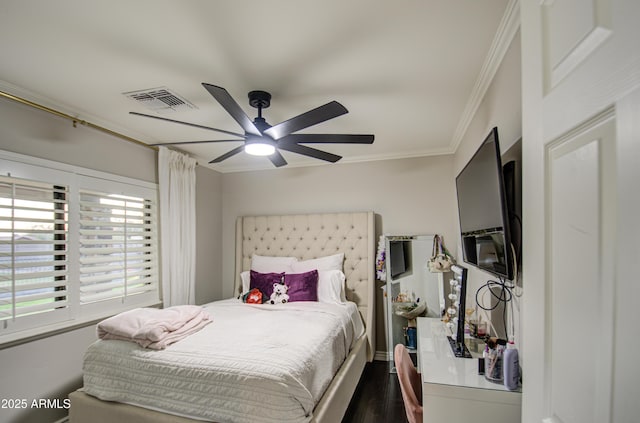 bedroom with dark hardwood / wood-style floors, ceiling fan, and crown molding