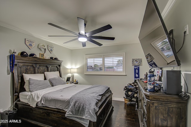 bedroom featuring ceiling fan, dark hardwood / wood-style floors, and ornamental molding