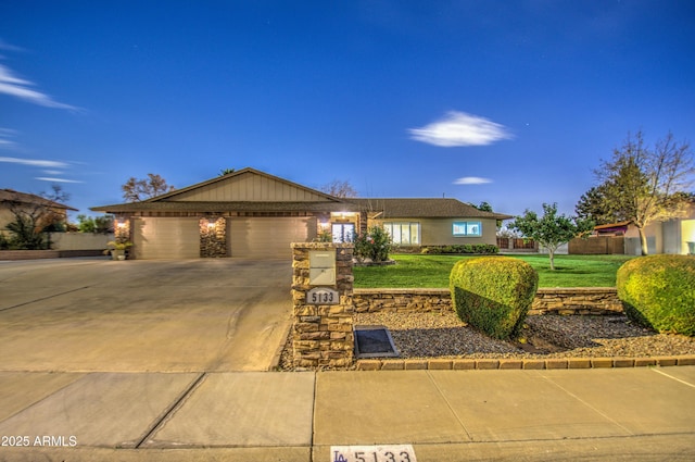 single story home featuring a garage and a front lawn