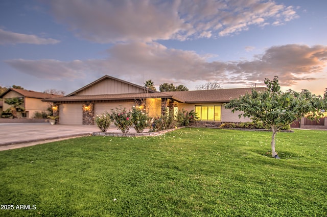 ranch-style house featuring a lawn and a garage