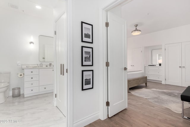 bathroom featuring vanity, hardwood / wood-style floors, and toilet