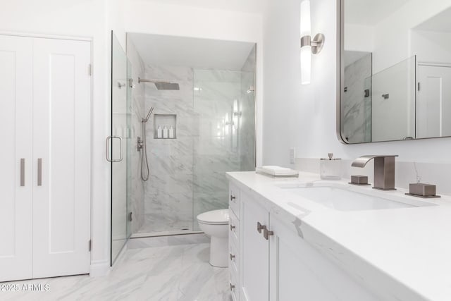 bathroom featuring vanity, toilet, and an enclosed shower