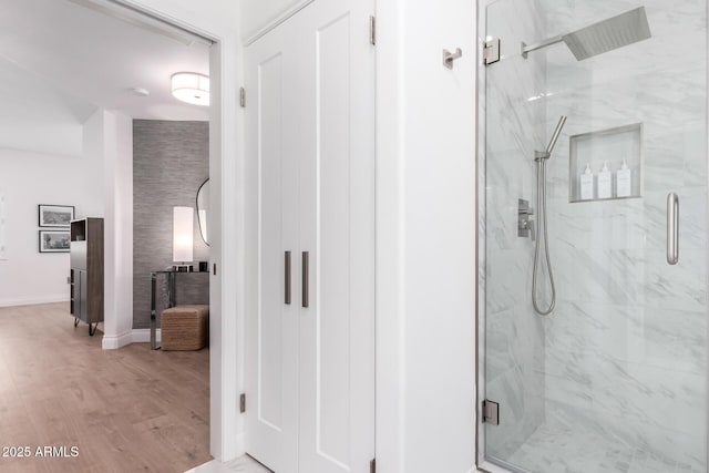 bathroom featuring wood-type flooring and an enclosed shower