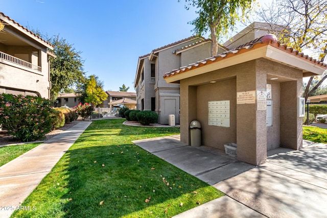 view of side of home with a yard