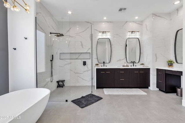 full bath with recessed lighting, a freestanding bath, a marble finish shower, and double vanity