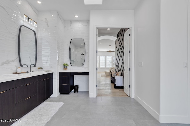 full bath with recessed lighting, ensuite bathroom, tile walls, and vanity