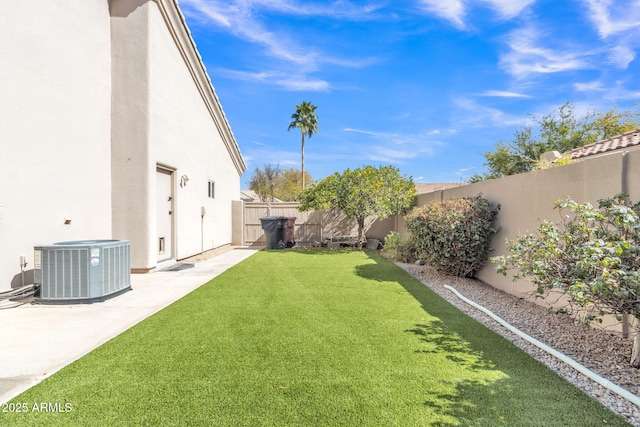 view of yard with central air condition unit, a patio area, and a fenced backyard