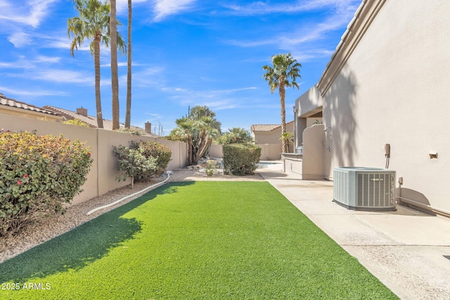 view of yard with a fenced backyard, a patio, and central air condition unit