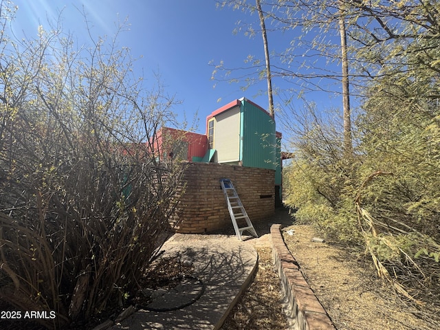 view of side of home with brick siding