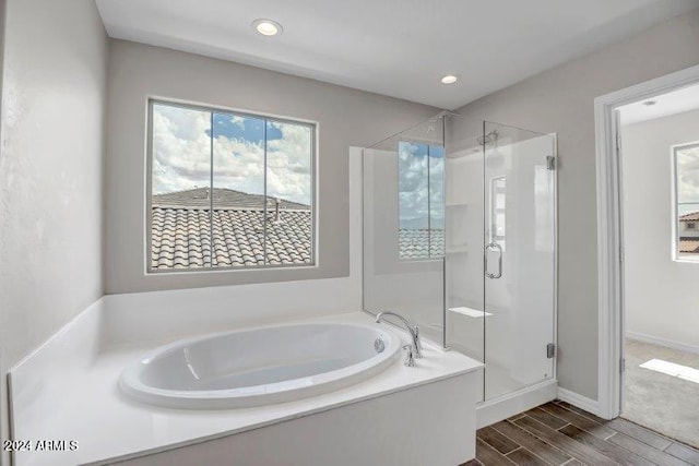 bathroom with hardwood / wood-style floors and plus walk in shower