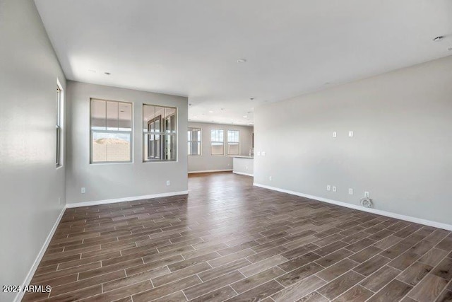 unfurnished room with dark hardwood / wood-style flooring