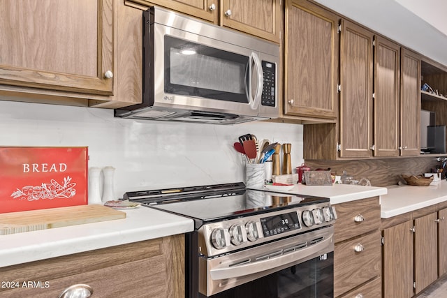 kitchen featuring appliances with stainless steel finishes and backsplash