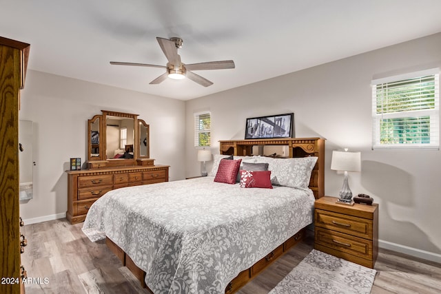 bedroom with ceiling fan and light hardwood / wood-style flooring