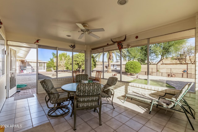 sunroom / solarium featuring ceiling fan