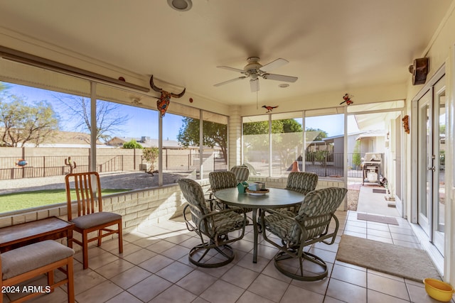 sunroom featuring ceiling fan