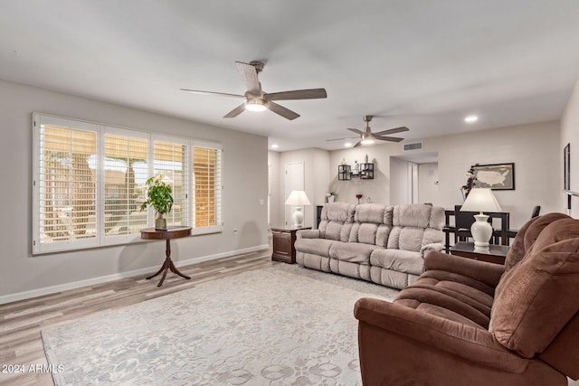 living room featuring ceiling fan and light wood-type flooring