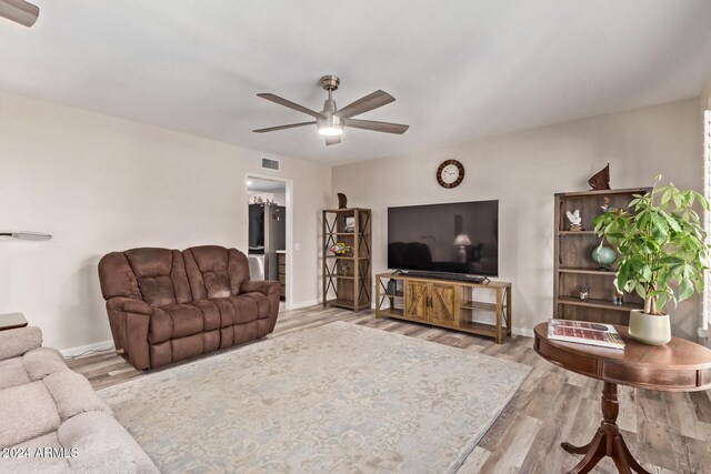 living room with hardwood / wood-style floors and ceiling fan