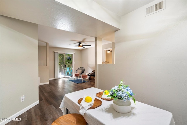 dining room with ceiling fan and dark hardwood / wood-style floors