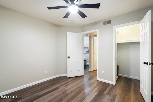 unfurnished bedroom featuring dark hardwood / wood-style flooring, a closet, and ceiling fan