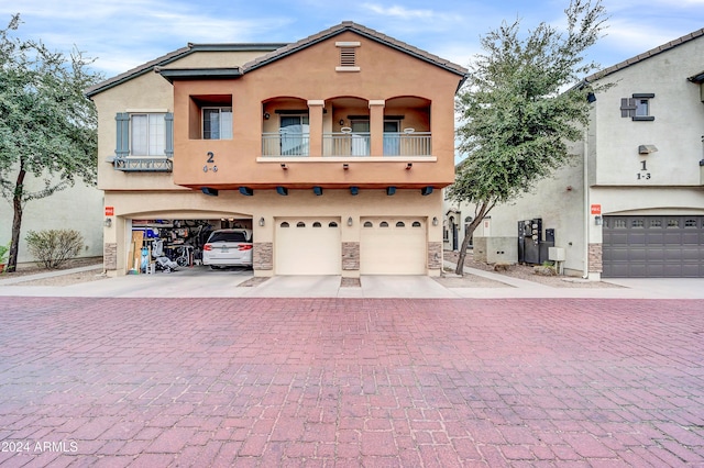 view of front facade with a garage and a balcony