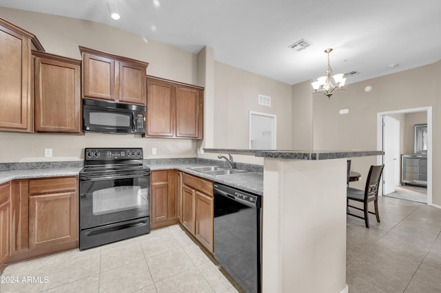 kitchen featuring a breakfast bar, sink, black appliances, light tile patterned floors, and an inviting chandelier