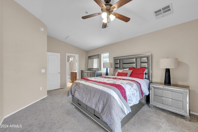 carpeted bedroom featuring ensuite bath, ceiling fan, and vaulted ceiling