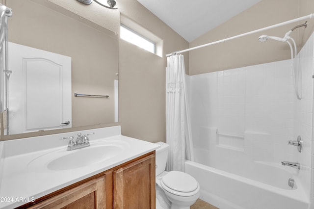 full bathroom featuring vanity, toilet, lofted ceiling, and shower / tub combo