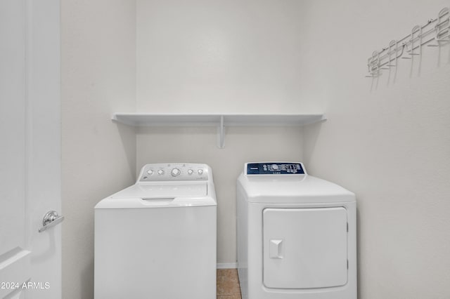 washroom featuring separate washer and dryer and light tile patterned floors