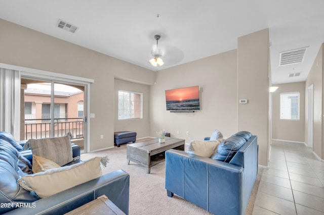 tiled living room featuring plenty of natural light and ceiling fan