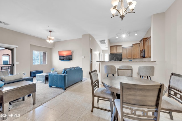 dining space featuring light tile patterned flooring and an inviting chandelier