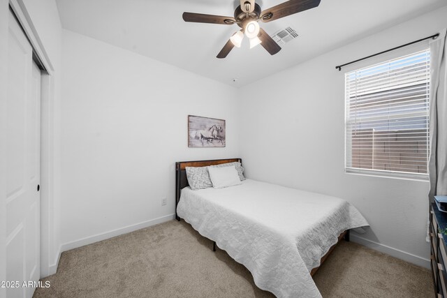 bedroom featuring visible vents, carpet flooring, baseboards, and a closet